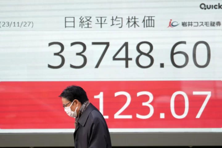 Stock market today: Asian shares mostly decline, as investors watch spending, inflation