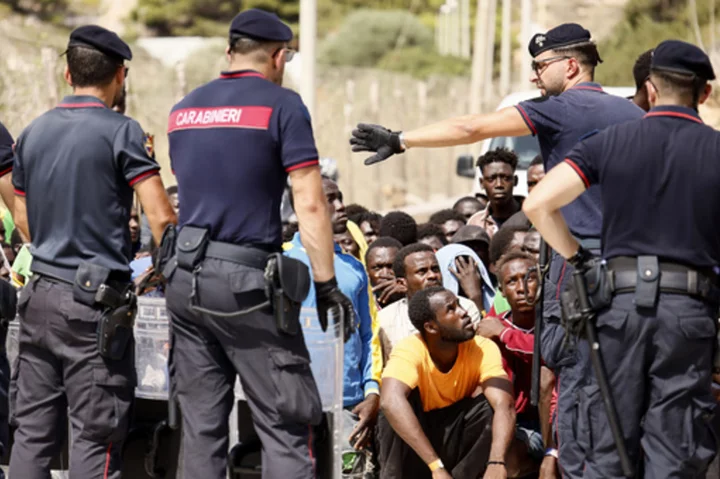 Top EU official heads to an Italian island struggling with migrant influx as Italy toughens stance