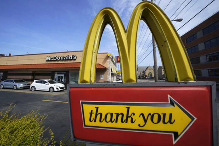 McDonald's promotions lure diners despite higher menu prices and revenue jumps 14%