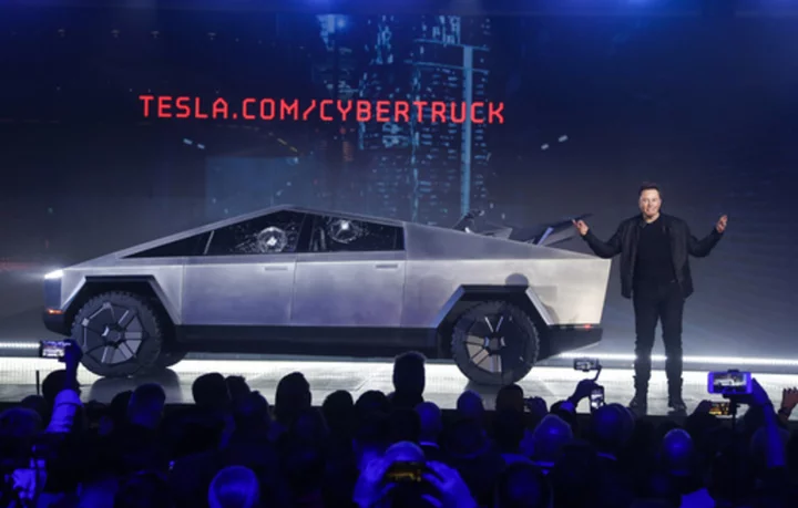 Tesla delivers 13 stainless steel Cybertruck pickups as it tries to work out production problems