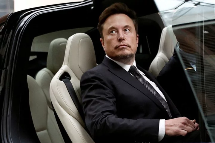 Analysis-Elon Musk and Tesla loom over Detroit's auto labor talks