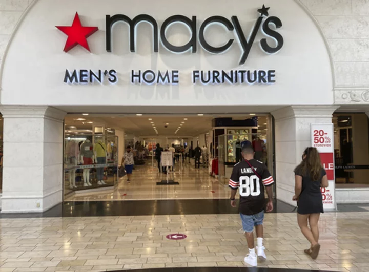 Macy's slashes expectations for the year after a pullback by shoppers in the spring