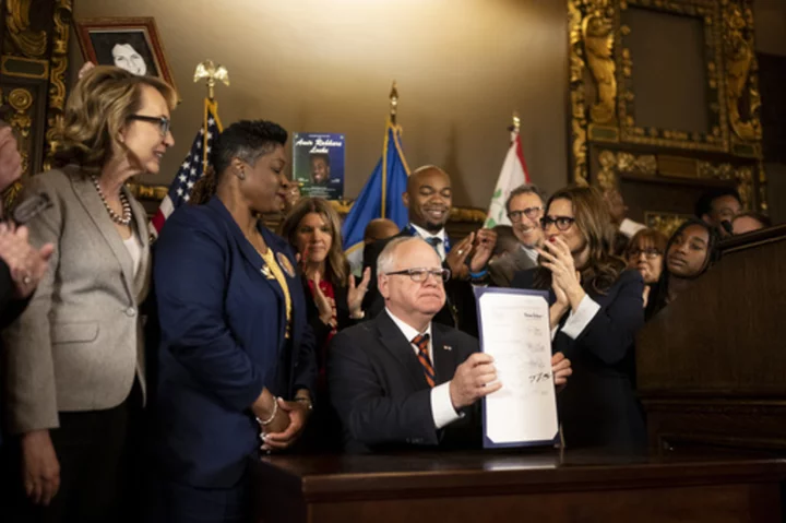 Minnesota governor signs gun safety measures: red flag law, expanded background checks