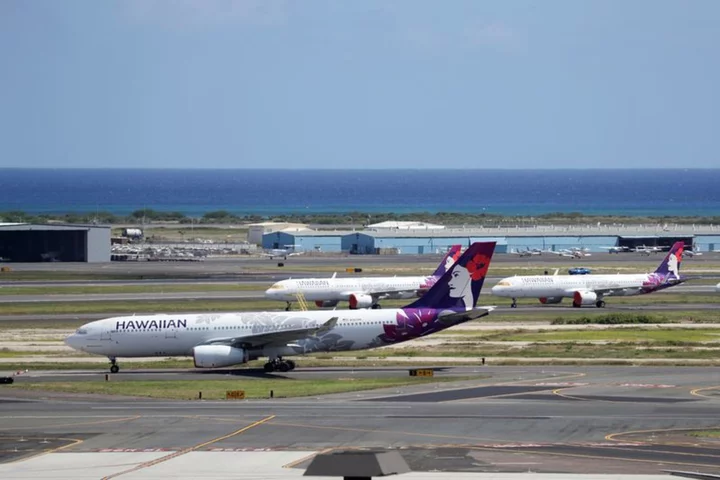 Hawaiian Airlines parent tempers outlook on Maui wildfire, engine issues