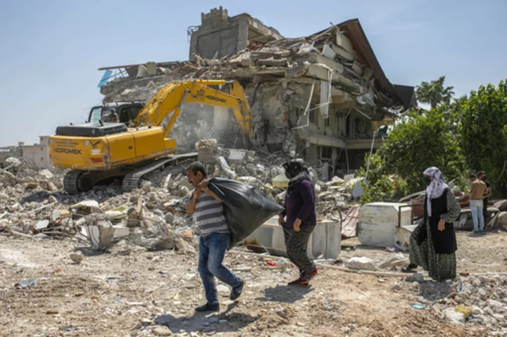 AP PHOTOS: In quake-devastated Turkey, voting in presidential election is no simple task
