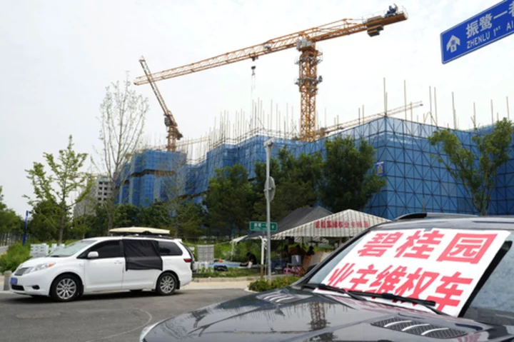 China's government tries to defuse economic fears after real estate developer's debt struggle