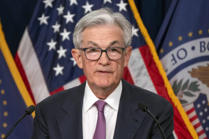 Fed keeps rates unchanged for first time in 15 months but signals 2 more potential hikes this year