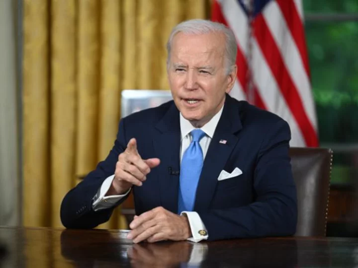 Biden signs debt ceiling deal into law, averting historic default