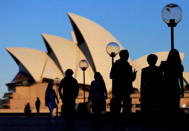 Australia eyes bigger budget surplus but warns economy still slowing