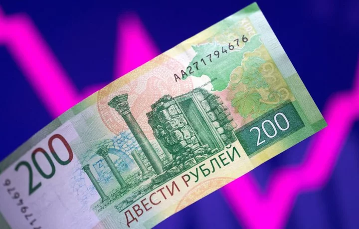 Russian central bank to hold emergency rate meeting as rouble tumbles